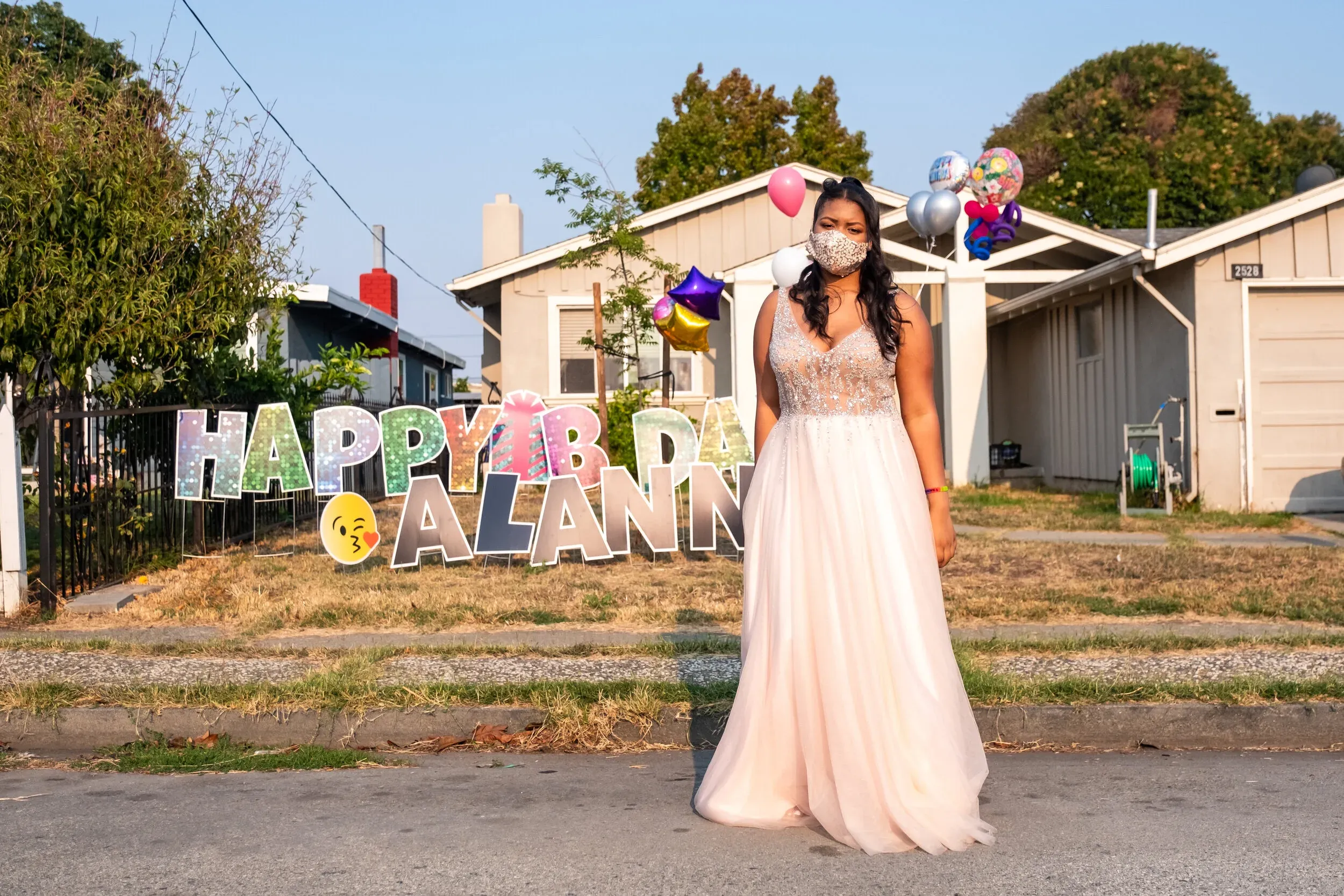 Alanna celebrating her 16th birthday with a Happy Birthday sign