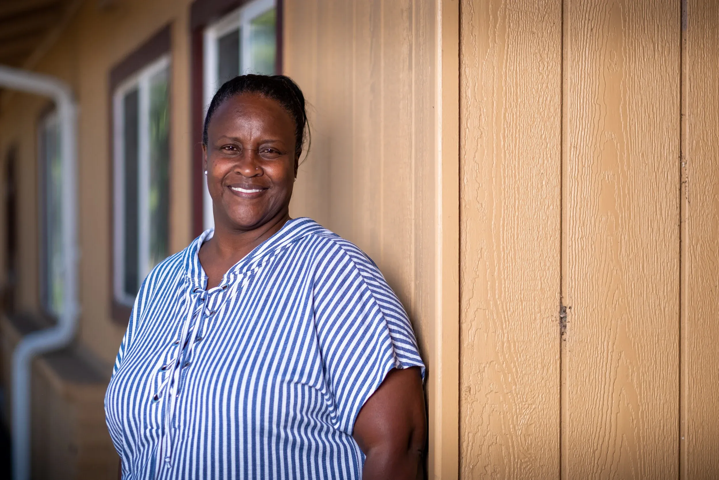 Lesia Preston, Executive Director of the Ecumenical Hunger Program, portrait in blue striped blouse