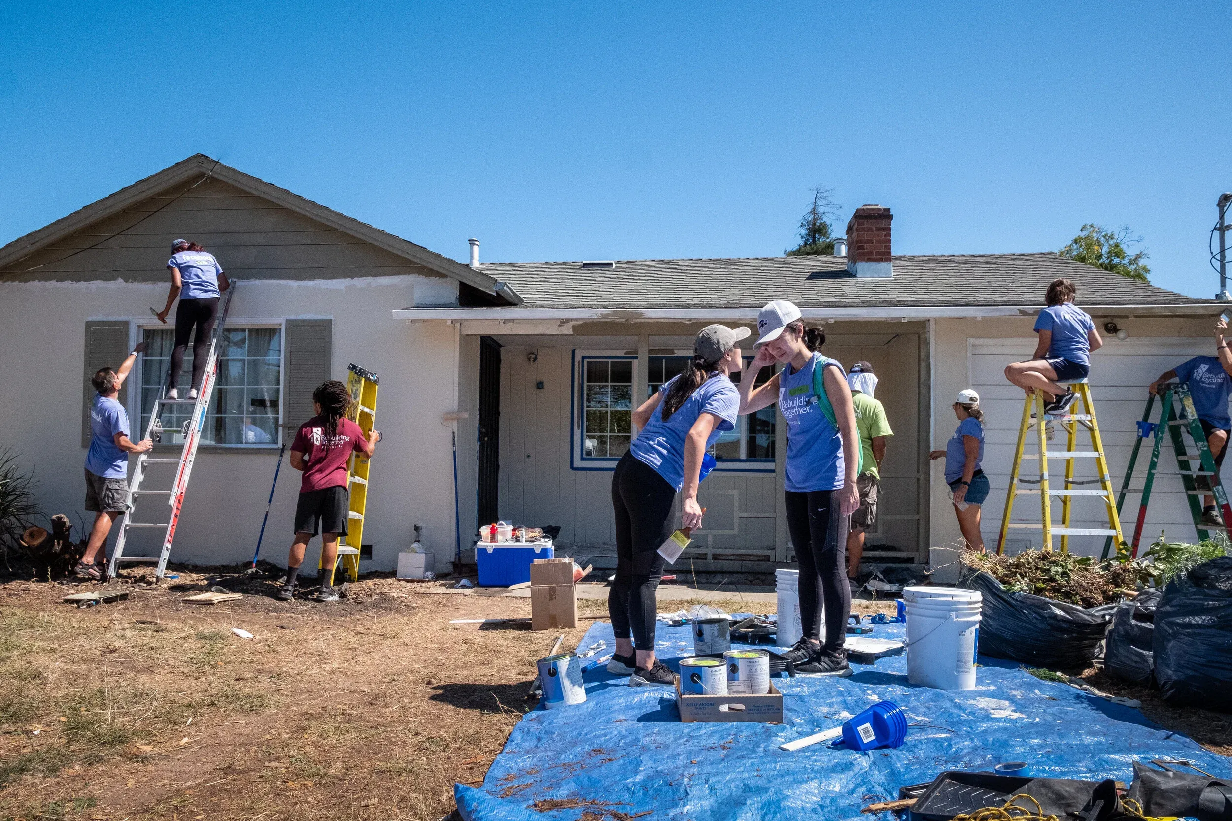 Rebuilding Together Peninsula volunteers painting a home in Belle Haven