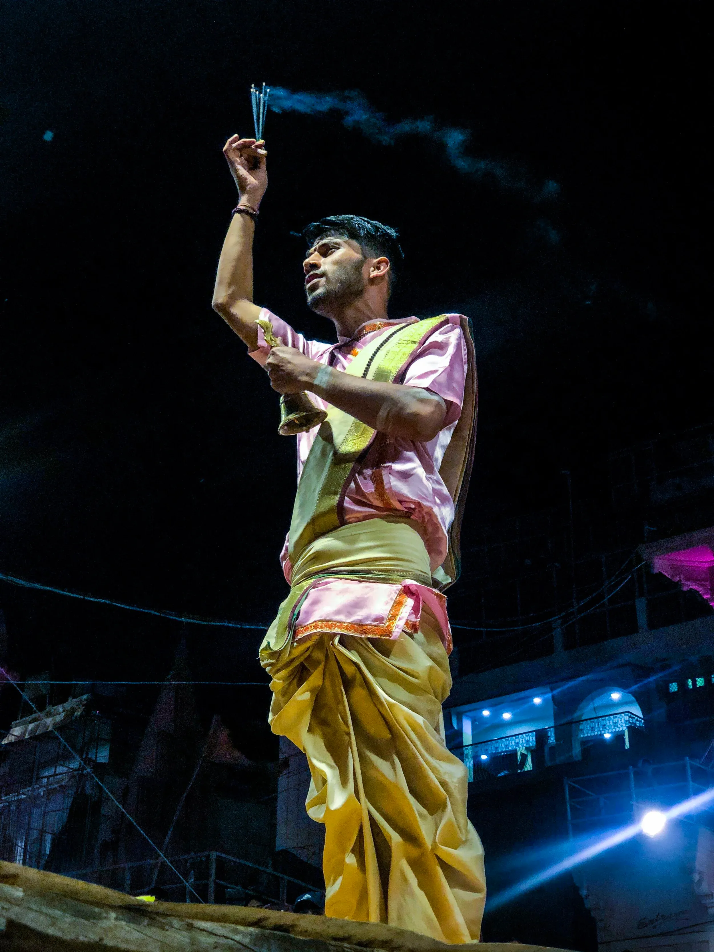 Hindu priests performing Aarti with lamps