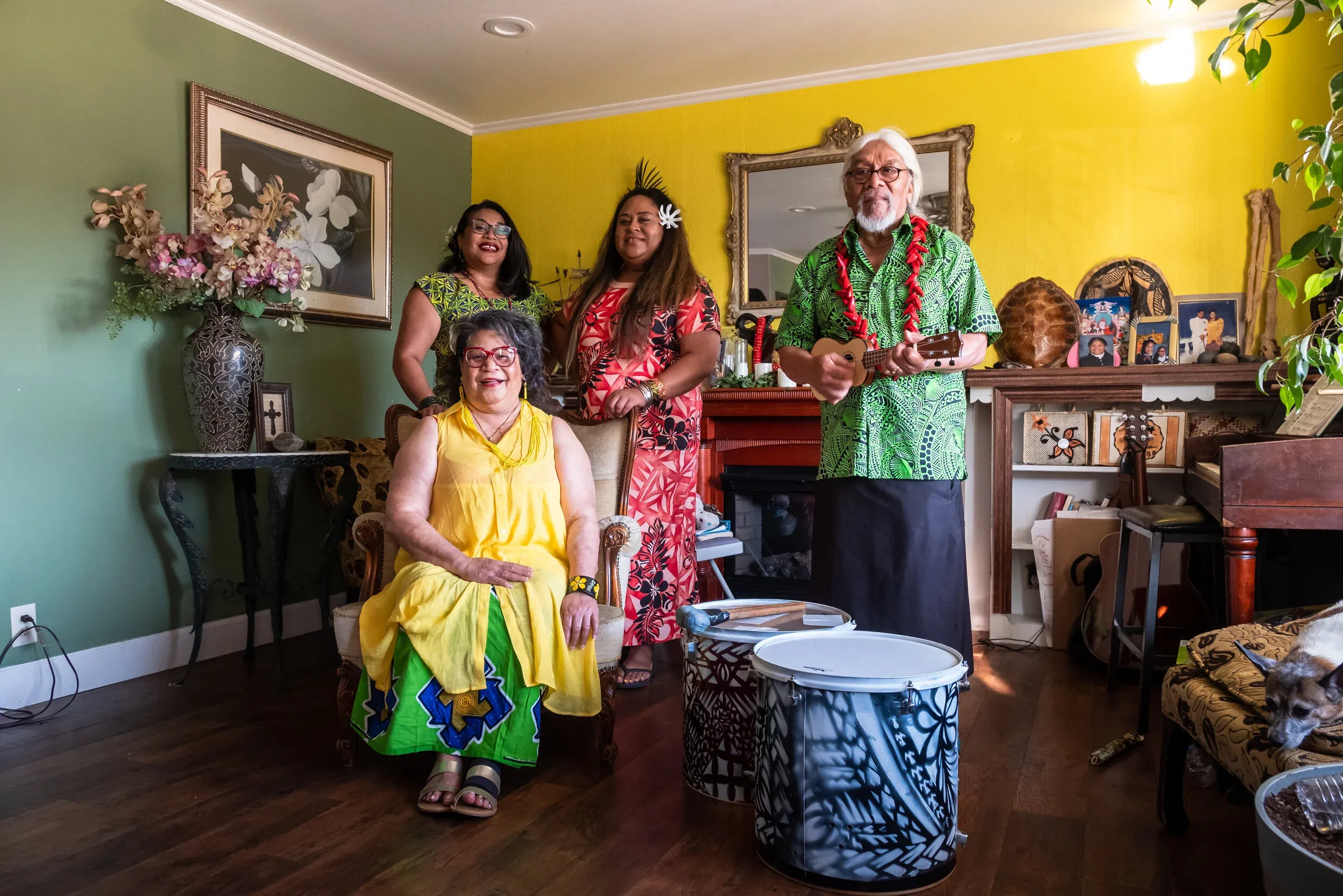 Mama Dee Uhila and family in their colorful island-styled living room with traditional Polynesian drums