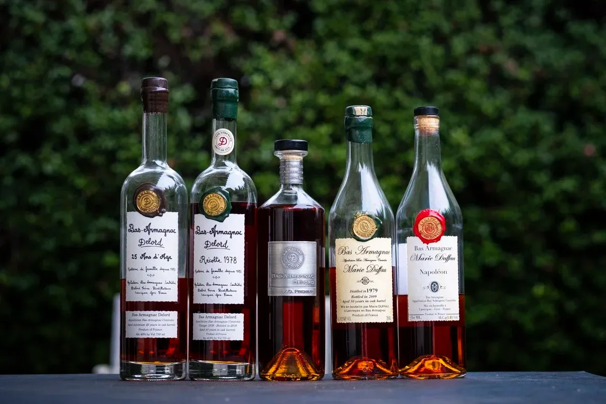 Five bottles of Armagnac Delord arranged in a display