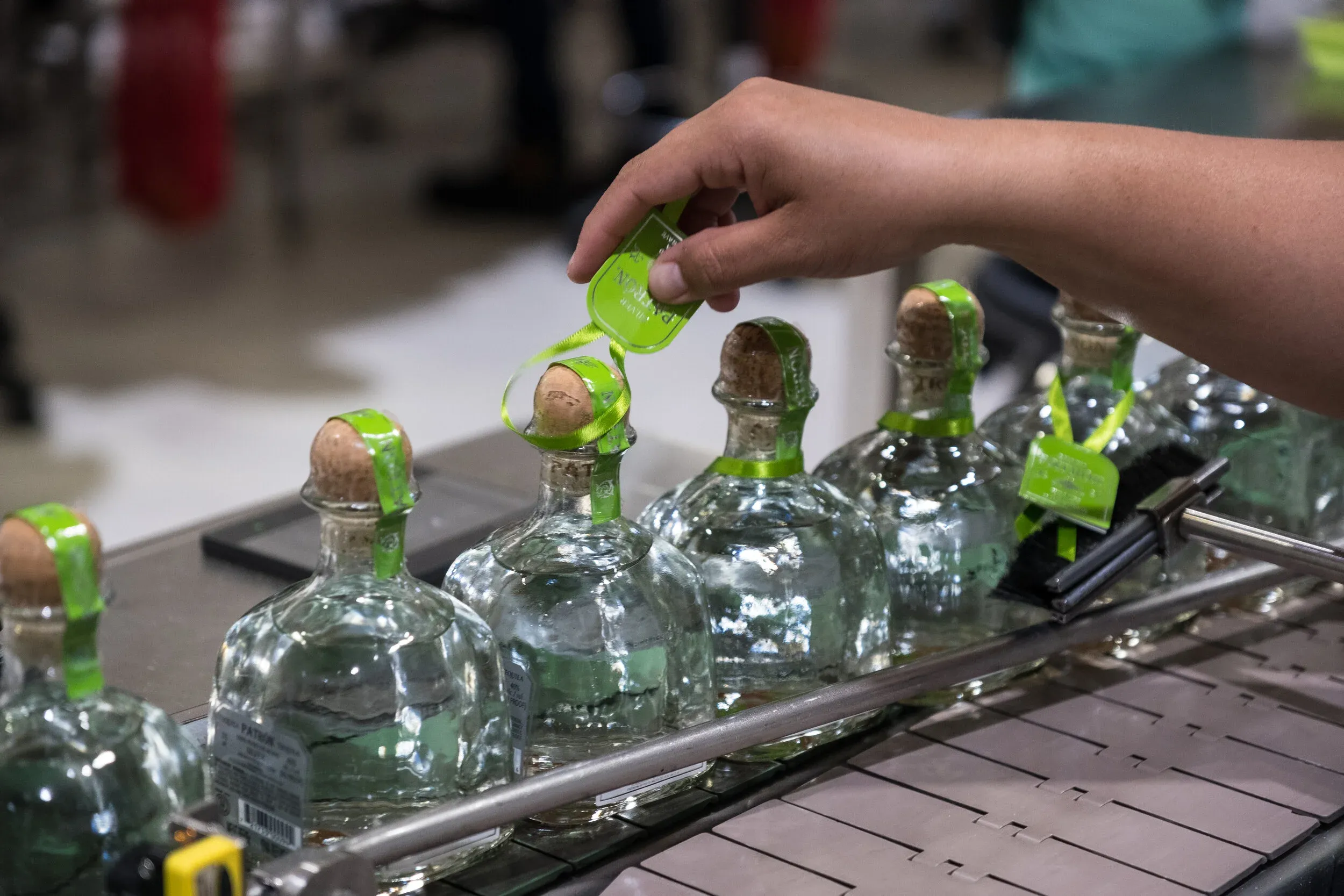 Hand-labeling Patrón bottles