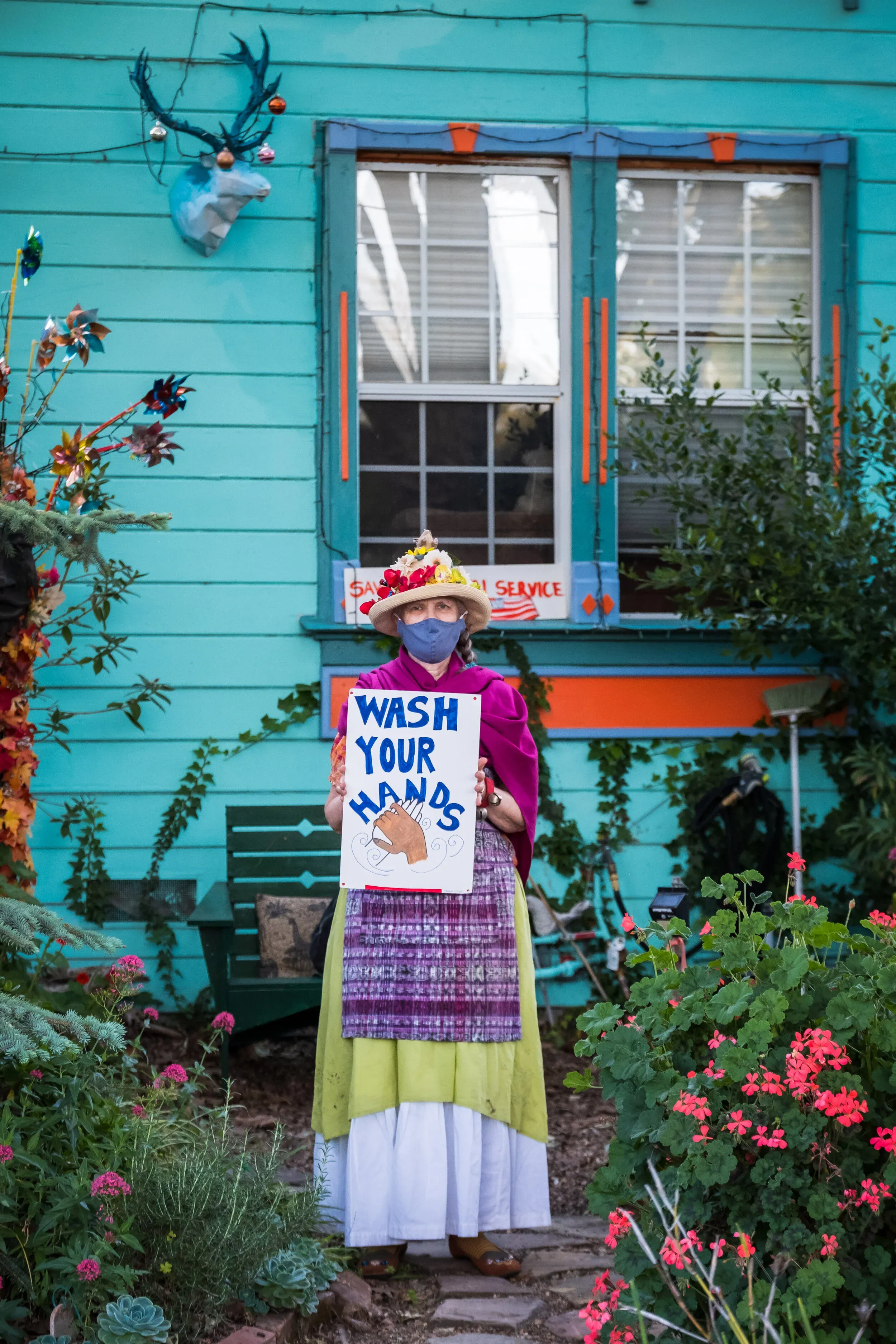 Family with wash your hands message on front steps