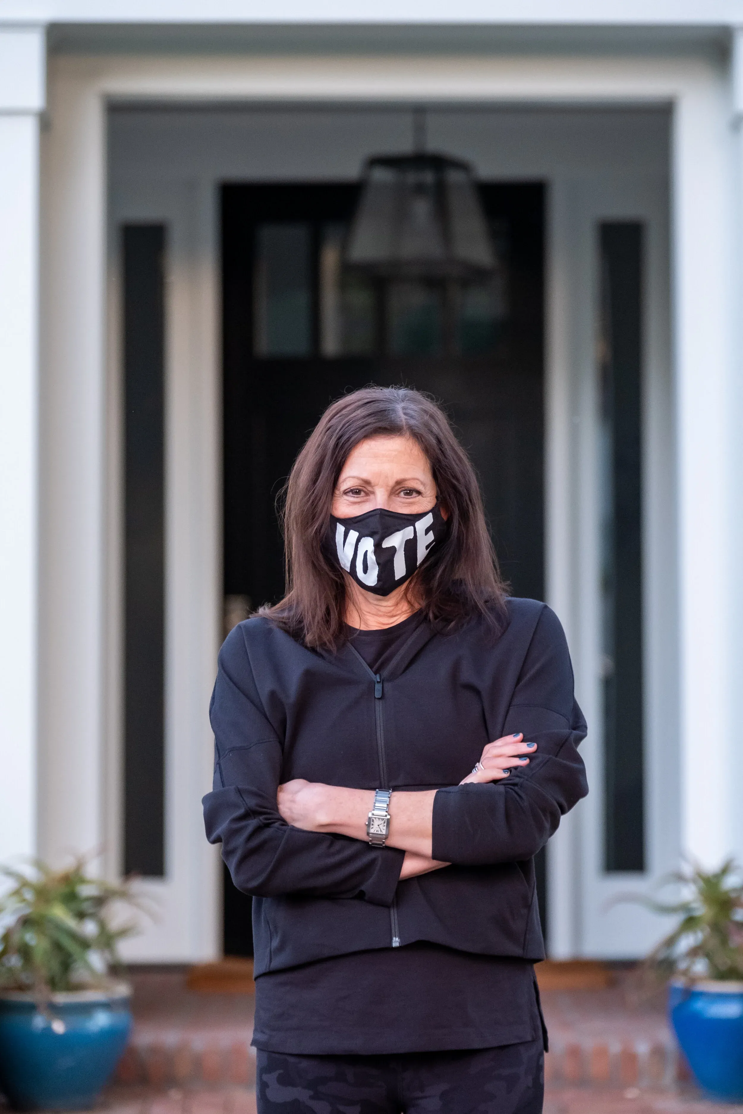Family with please vote message on front steps